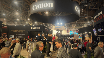Image of NAB 2023 trad show floor with Canon logo dominating and people in foreground